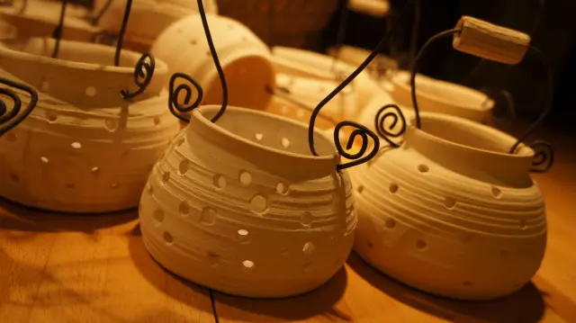 Pots with wire spirals in warm light, close up